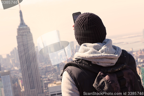 Image of Tourist taking photo of New York City.