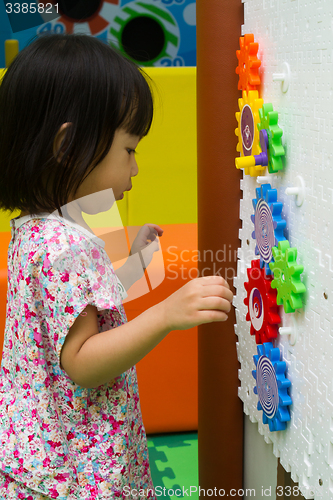 Image of Chinese girl solving puzzle