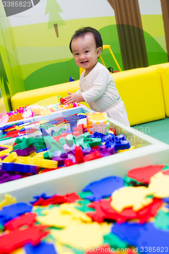 Image of Chinese baby playing puzzle