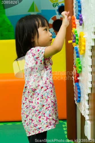 Image of Chinese girl solving puzzle