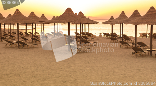 Image of Tropical beach huts at sunrise