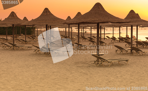 Image of Tropical beach huts at sunrise