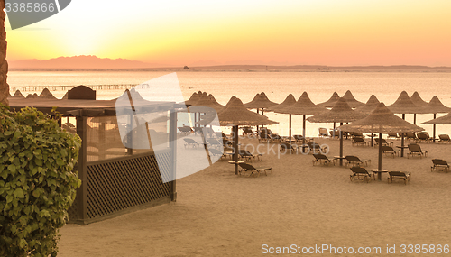 Image of Tropical beach huts at sunrise