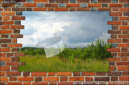 Image of hole in the brick wall and bushes before thunder 