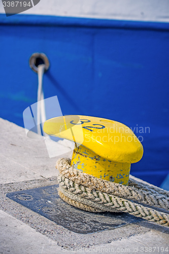 Image of Bollard with mooring line of a trawler