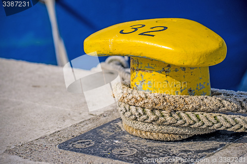 Image of Bollard with mooring line of a trawler