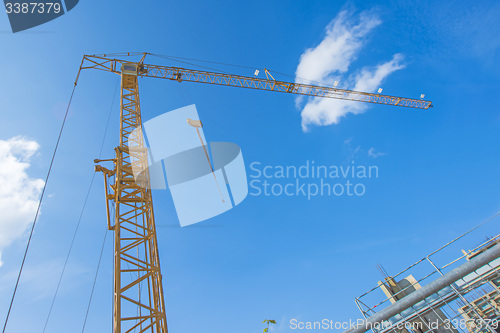 Image of Building crane with house construction