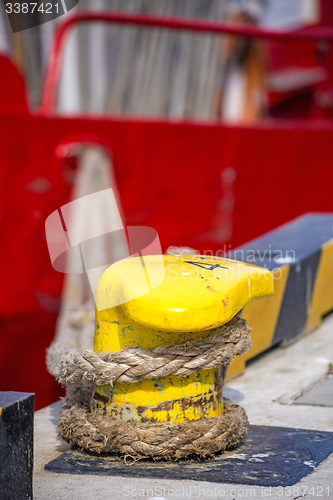 Image of Bollard with mooring line of a trawler