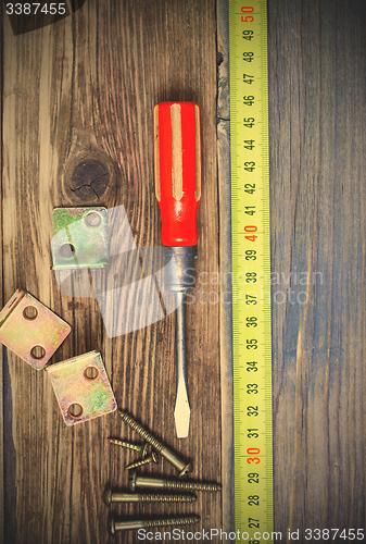 Image of Vintage screwdriver, screws, angles and measuring tape