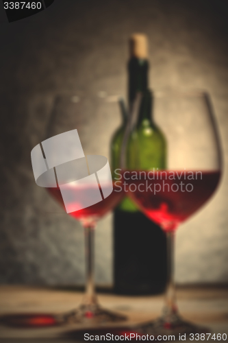 Image of red wine in glass and bottle