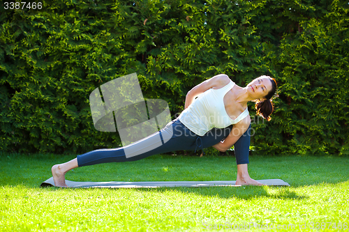 Image of pretty adult woman practicing yoga