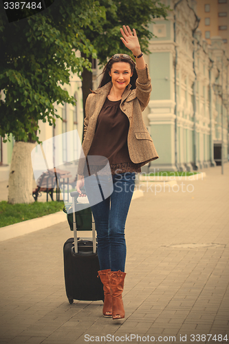 Image of pretty adult woman traveler with suitcase