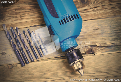 Image of electric drill with a set of drill bits