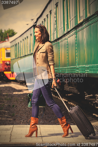 Image of beautiful adult woman with a luggage