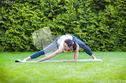 Image of pretty adult woman doing yoga