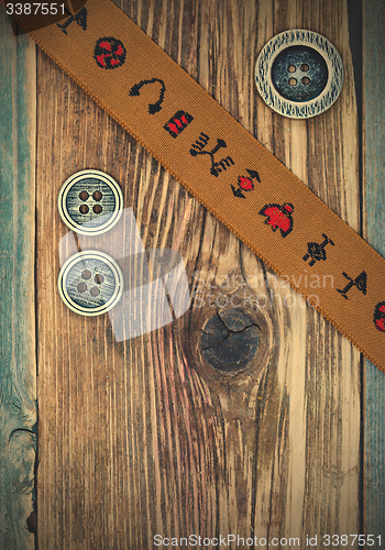 Image of vintage band with embroidered ornaments and old button