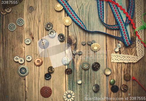 Image of scattered vintage buttons and diverse colored band