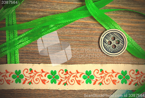 Image of vintage embroidered band and tape with old classic button