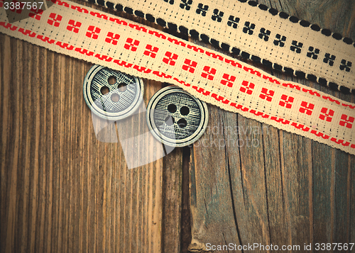 Image of vintage ribbons with embroidered ornaments and old button