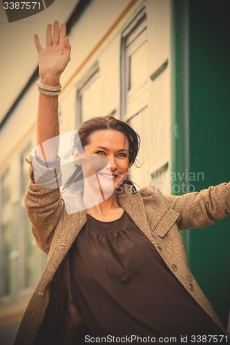 Image of woman waving hand from the passenger wagon