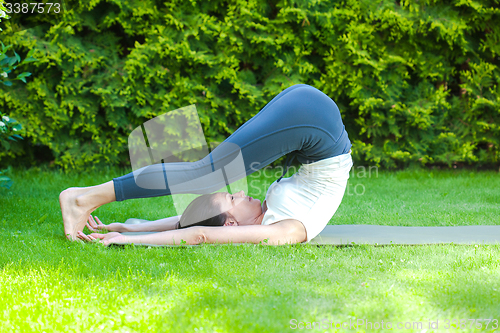 Image of beautiful adult woman doing yoga