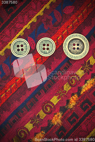 Image of vintage tape with embroidered ornaments and old buttons