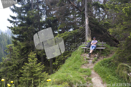 Image of Hiker takes a break and enjoys the view