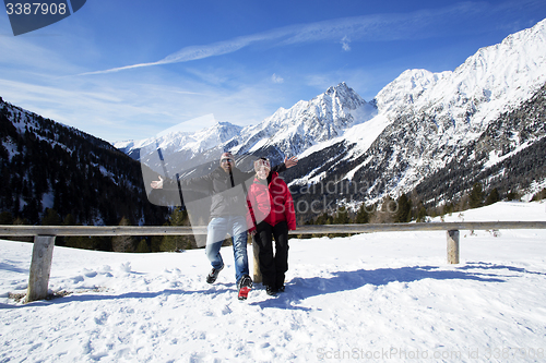 Image of Happy couple having fun in winter landscape 