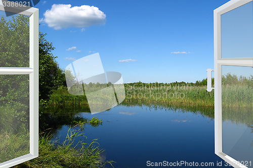Image of opened window to the summer lake