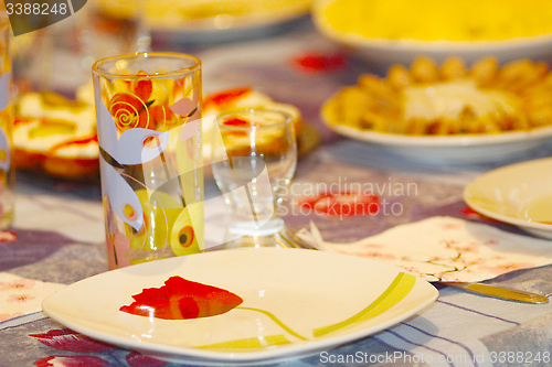 Image of crockery glass plate and wine-glass on the table