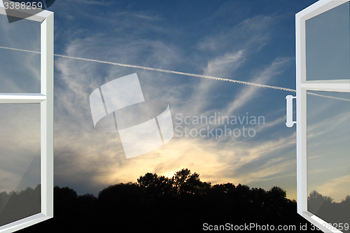 Image of window opened to the sunset