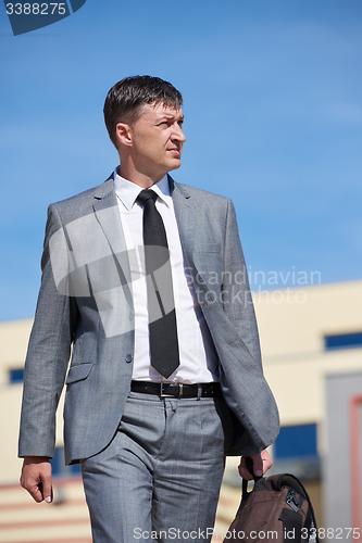 Image of senior  businessman outdoors