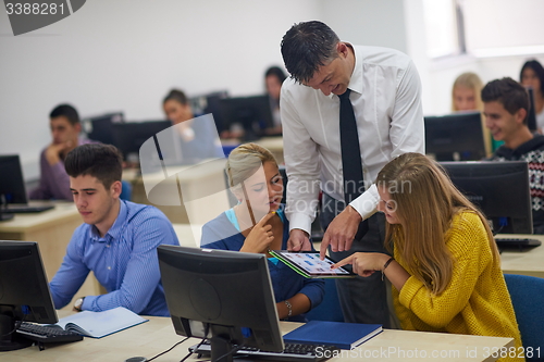 Image of students with teacher  in computer lab classrom