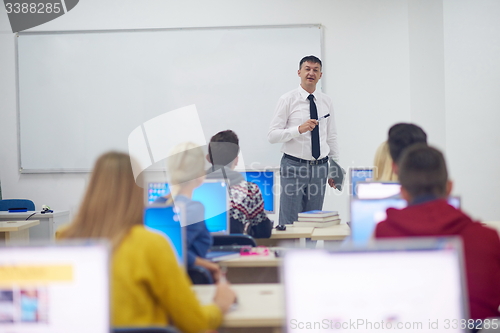 Image of students with teacher  in computer lab classrom