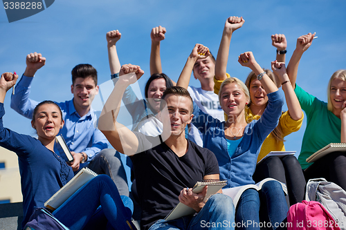 Image of students outside sitting on steps