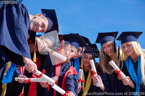 Image of young graduates students group