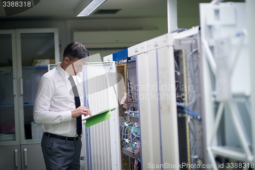 Image of network engineer working in  server room