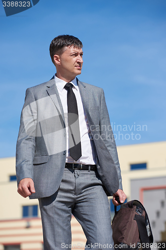 Image of senior  businessman outdoors