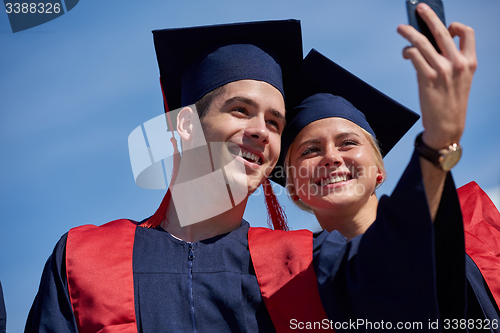 Image of students group in graduates making selfie