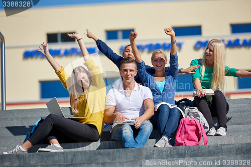 Image of students outside sitting on steps