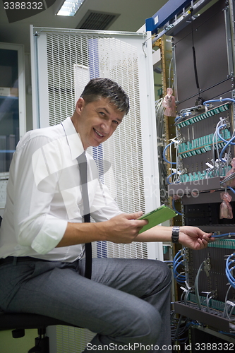 Image of network engineer working in  server room