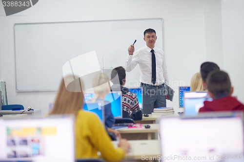 Image of students with teacher  in computer lab classrom