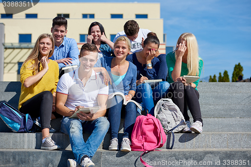 Image of students outside sitting on steps