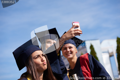Image of students group in graduates making selfie
