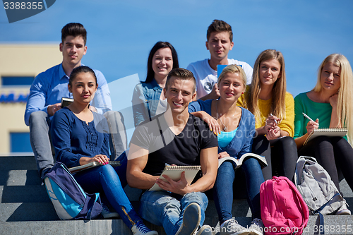 Image of students outside sitting on steps