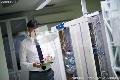 Image of network engineer working in  server room