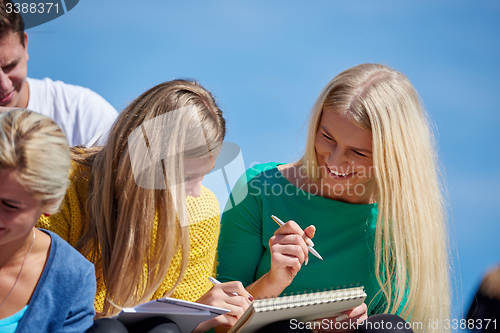 Image of students outside sitting on steps