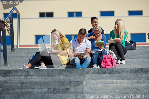Image of students outside sitting on steps