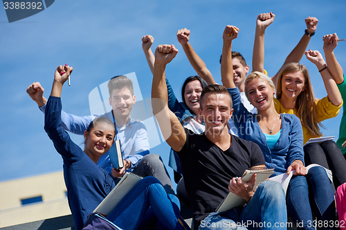 Image of students outside sitting on steps