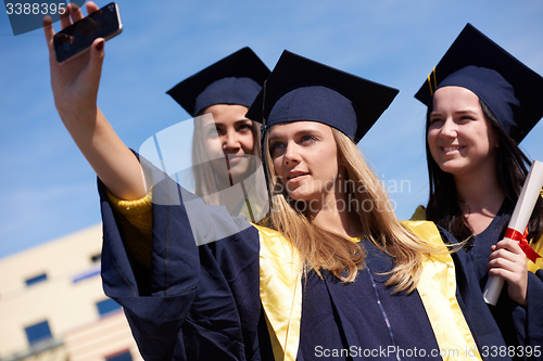 Image of students group in graduates making selfie